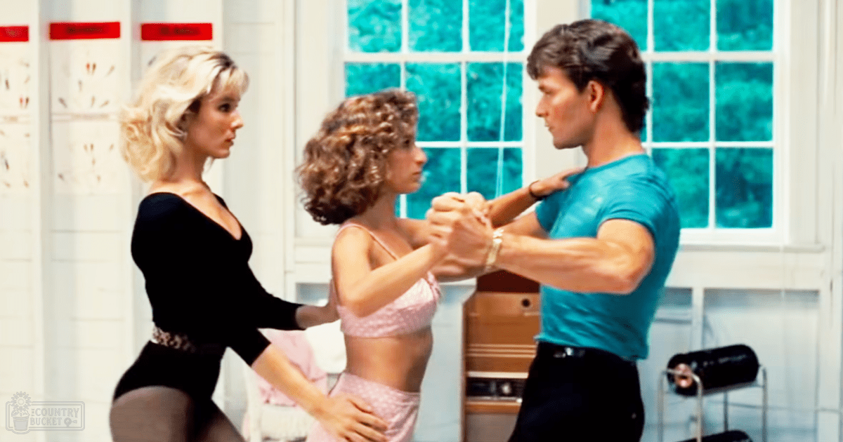 An indoor fitness or dance class scene with adults in athletic attire.