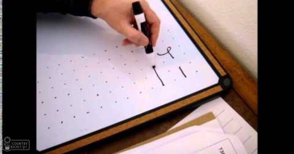 A hand drawing with a marker, indoor scene with small dots printed paper, black marker, wooden frame, white background