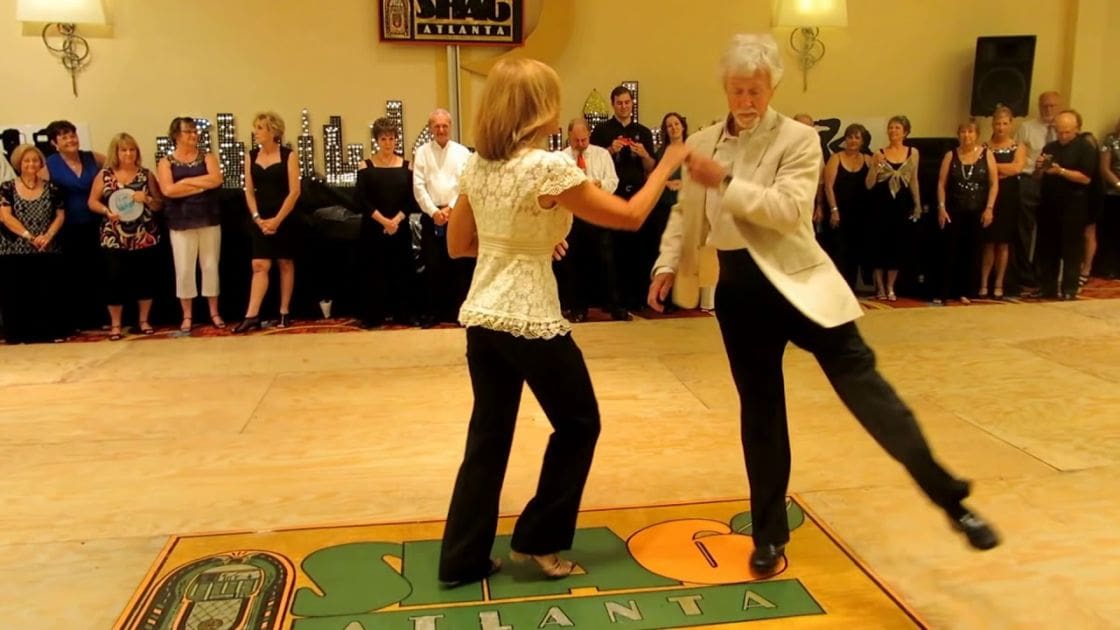 A dance couple in Atlanta, Georgia; a ballroom event with spectators watching the dance at night.