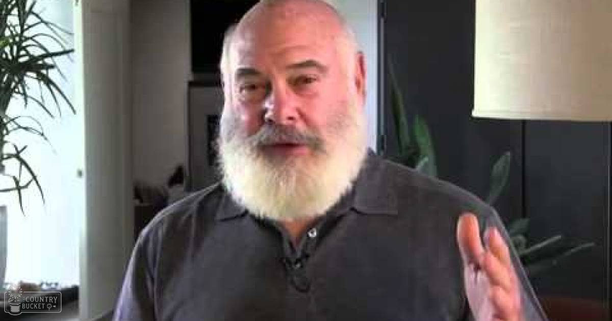 An older adult male in a cozy indoor home environment, wearing a dark gray polo shirt with cotton fabric.
