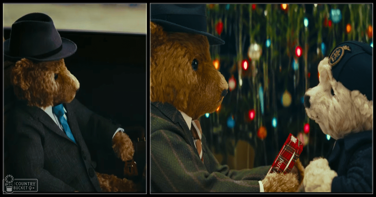 Two teddy bears dressed formally, one as a police officer holding 'Pride,' indoors with holiday lights.