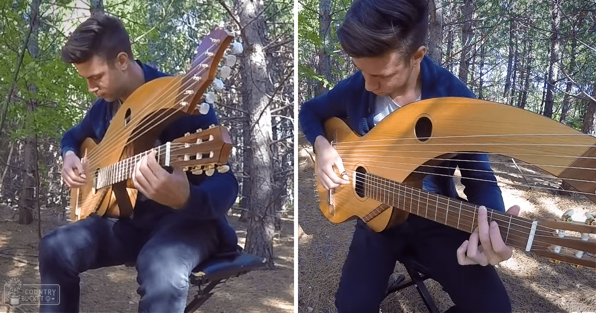 A young adult male plays a stringed instrument in a forest setting during spring or summer, under natural daylight.