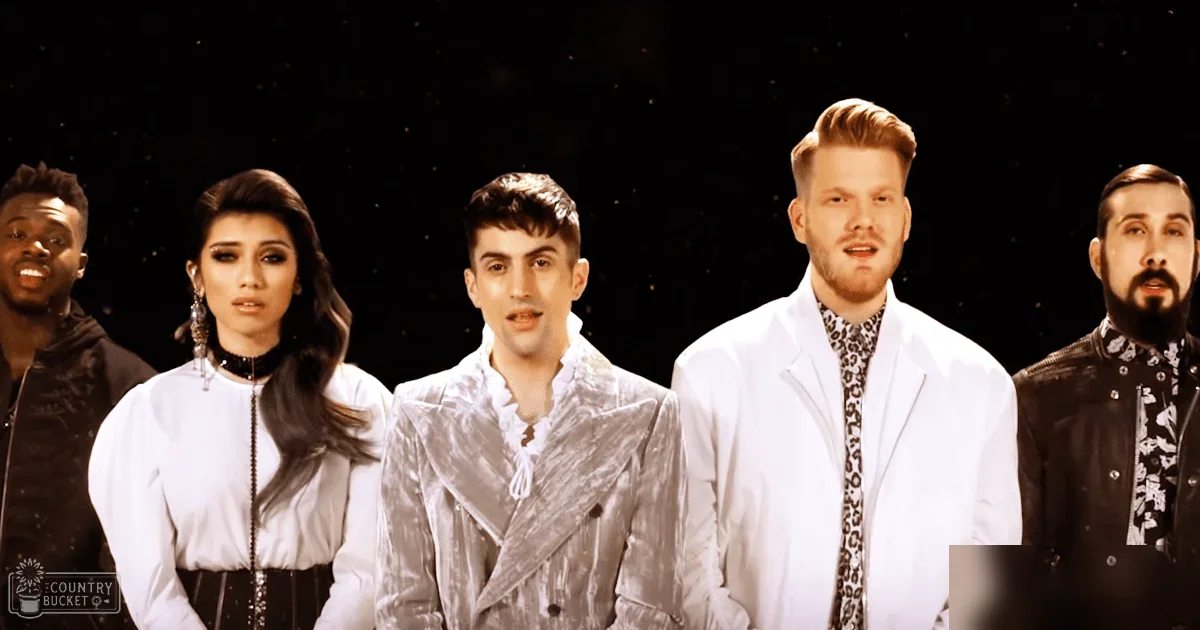 A group of performers on stage with a night sky or space backdrop.
