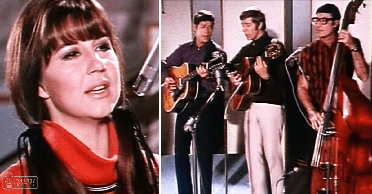 Adult female singer with shoulder-length brown hair, wearing an orange top in a recording studio setting with three musicians behind her.