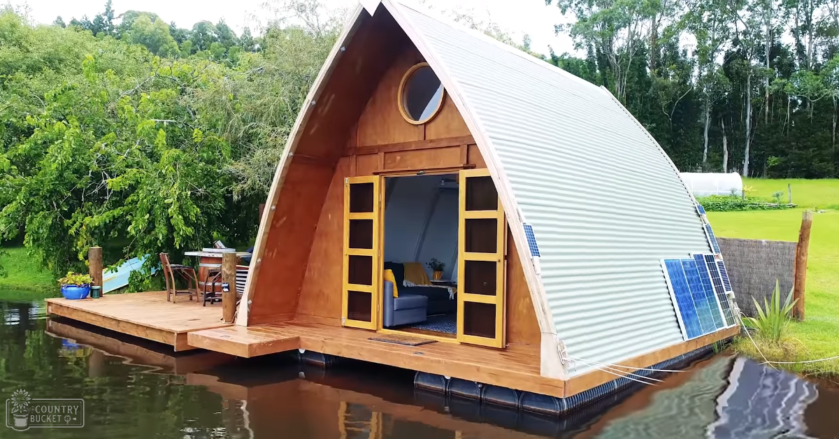Serene outdoor setting with a floating cabin surrounded by trees and grass, solar panels on the side, spring or summer season, daytime light