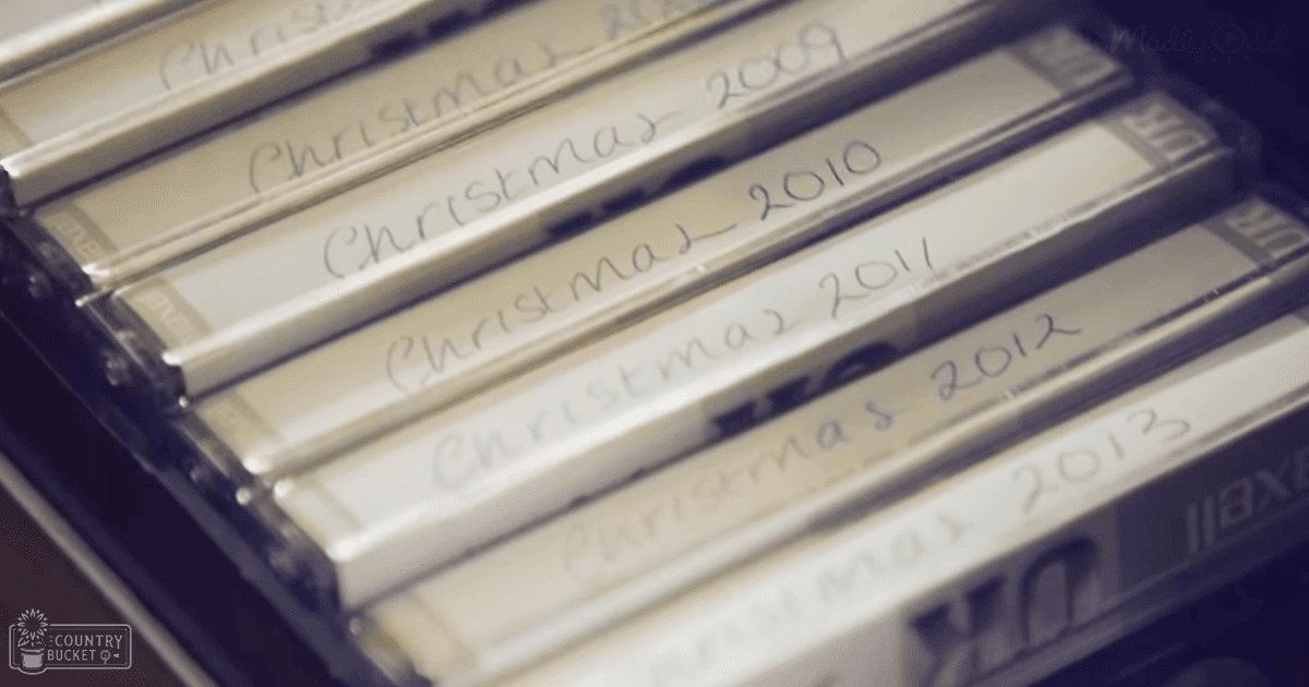 Five labeled video tapes with handwritten Christmas year labels from 2009 to 2013, stored indoors in a home or office setting.