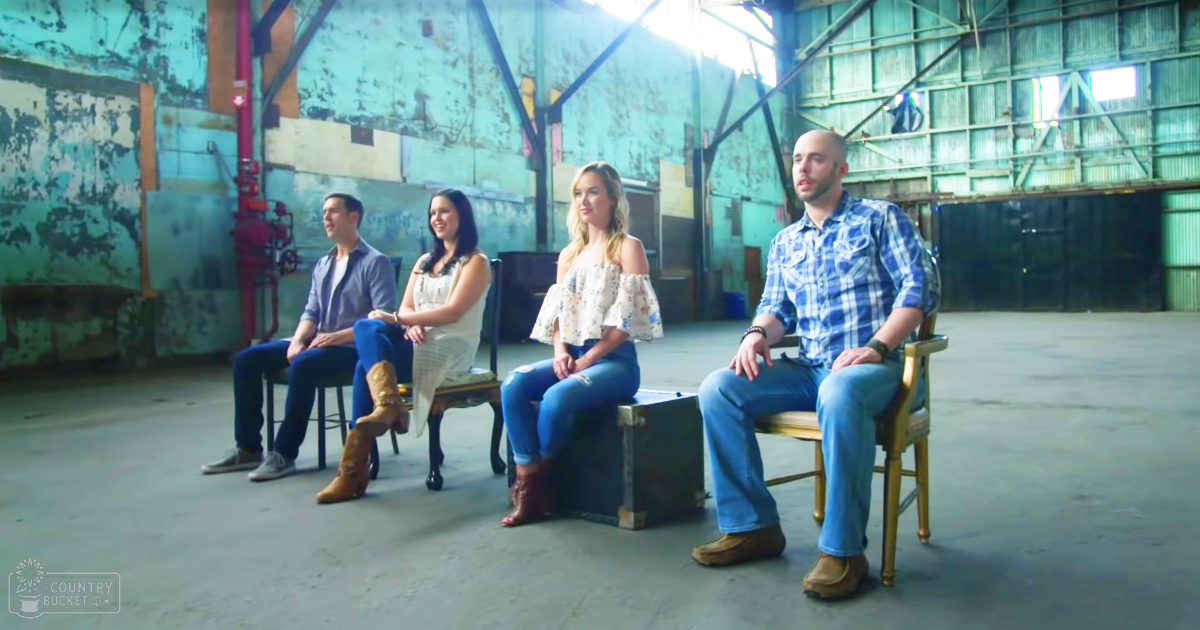 Four young adults in an industrial warehouse setting, wearing casual attire with a mix of blue jeans, floral dresses, and button-up shirts.