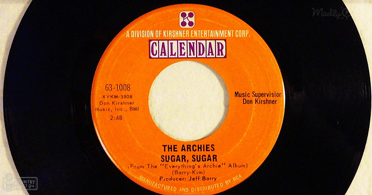 Close-up of a vinyl record label for 'Sugar, Sugar' by The Archies with text details against an indoor background.
