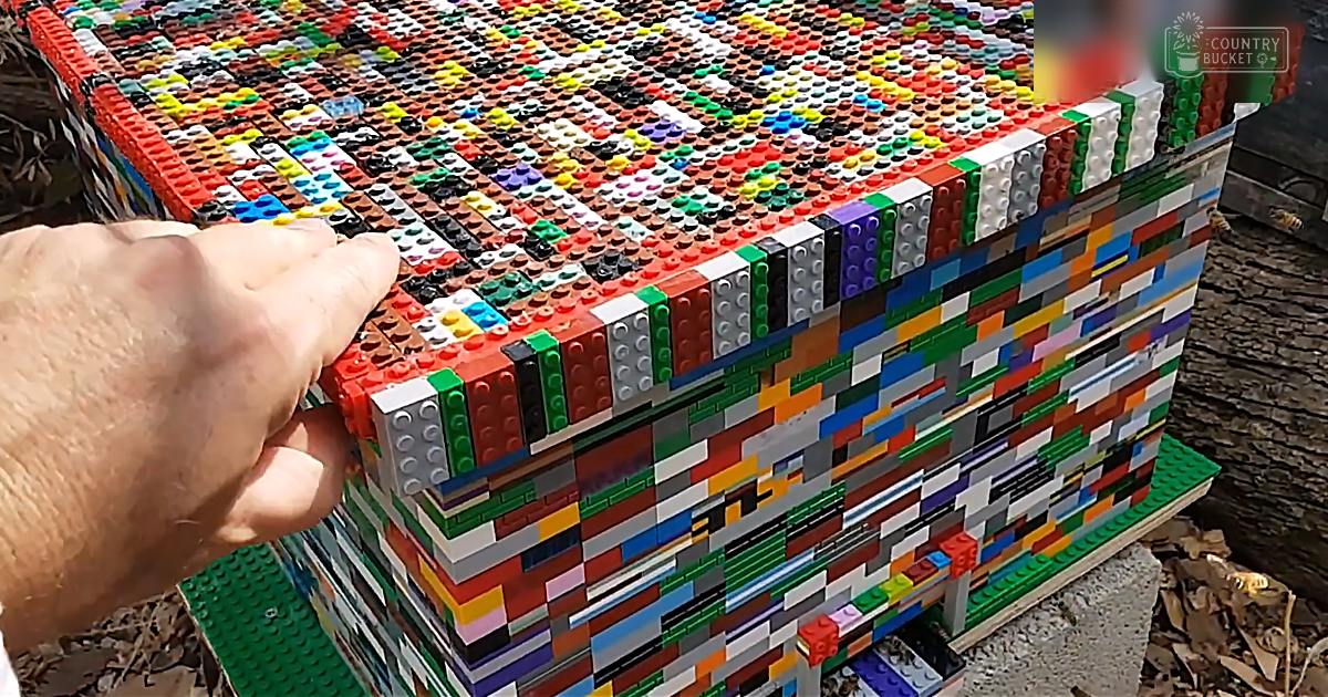A large LEGO structure with intricate patterns in a garden or park setting during daytime