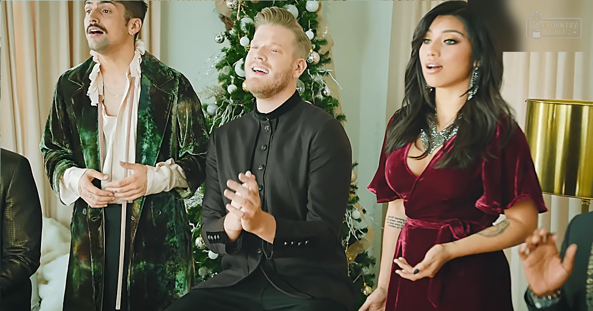 Group singing in front of a Christmas tree; winter holiday setting with natural light.