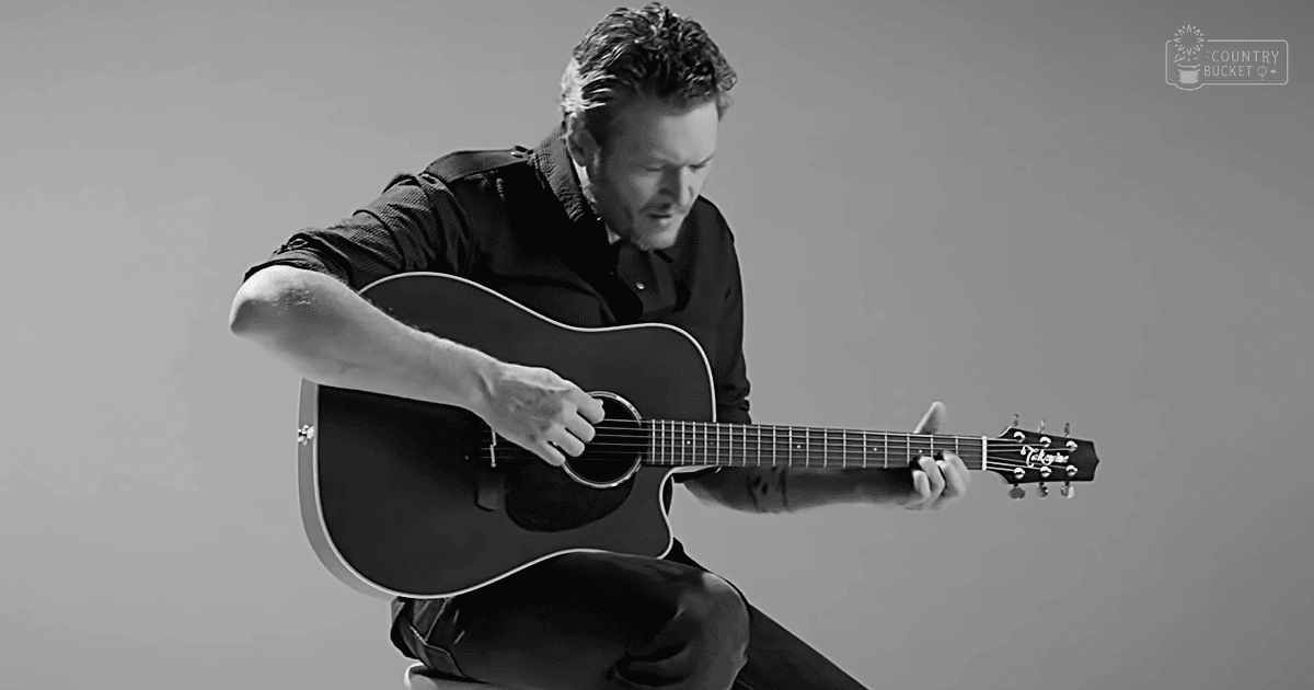 An adult male musician in a studio setting plays an acoustic guitar with text 'Madly Odd' visible.