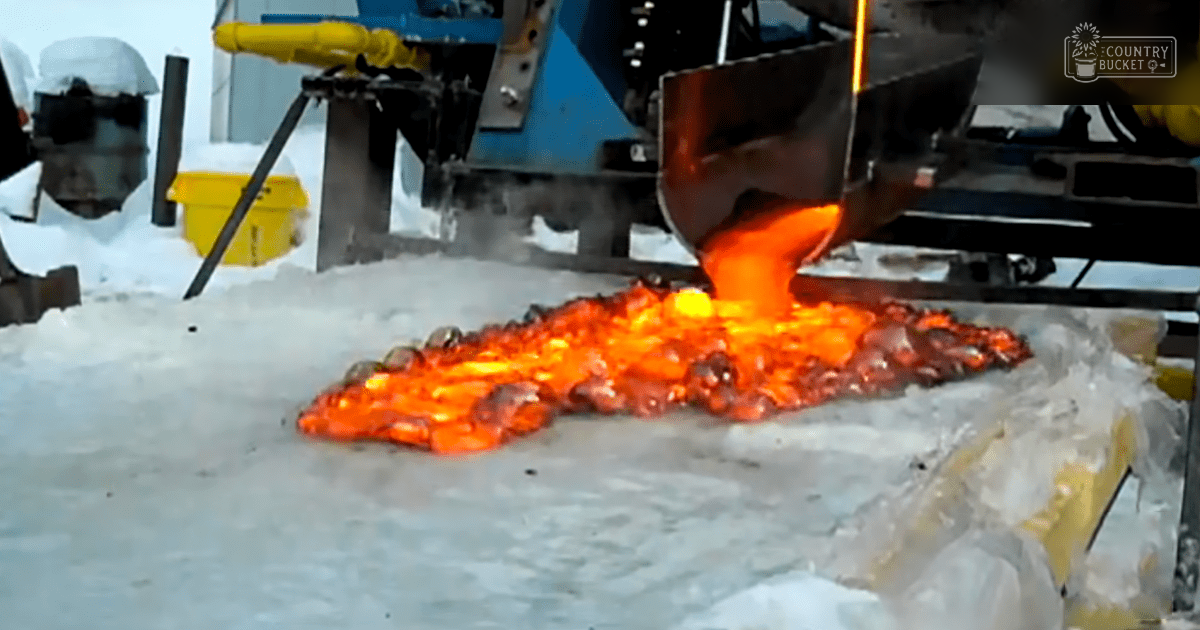 Metal casting process in an industrial outdoor setting with snow or ice, machinery, molten metal pouring into mold