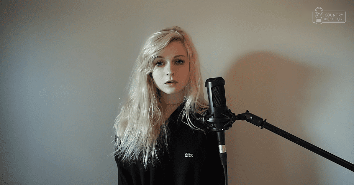 Young adult female wearing a black Lacoste polo shirt with crocodile logo, in an indoor recording studio setting.