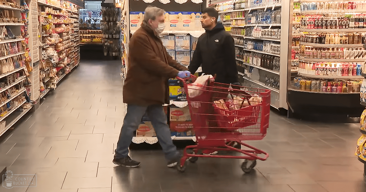 Two individuals shopping for matzo in a well-lit grocery store aisle, wearing casual attire and face masks.