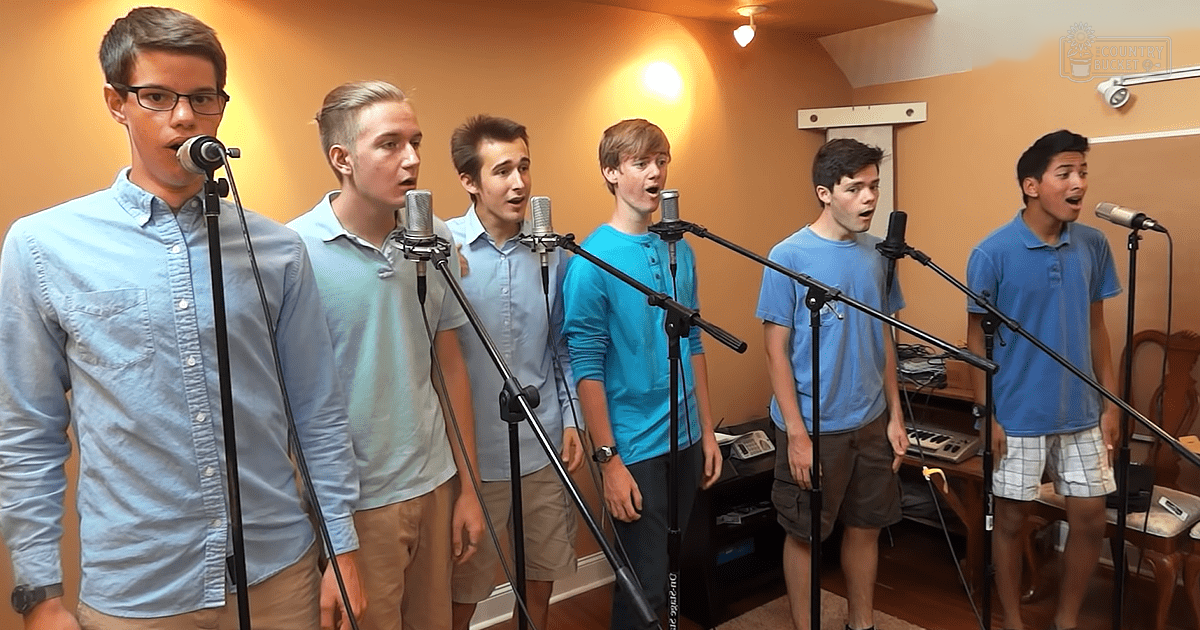 Young adults singing in a home studio with microphones and audio equipment.