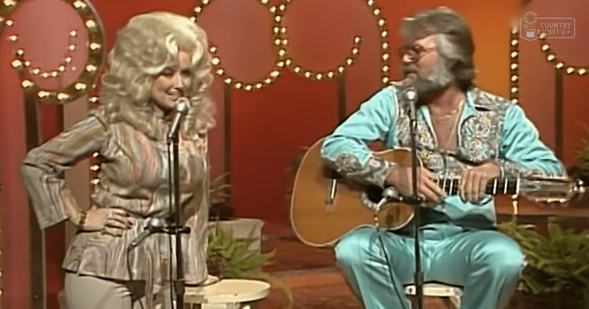Musical performance indoors, two individuals in shiny silver and turquoise outfits against a warm-toned circular backdrop.