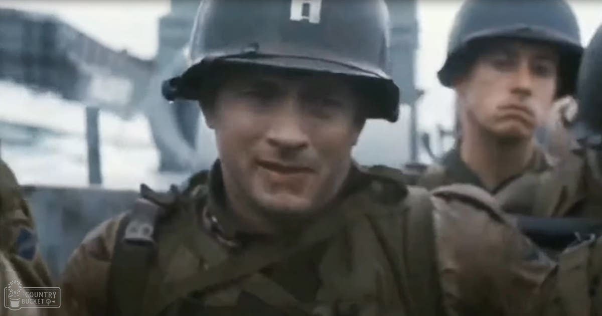 Two adult male soldiers in military uniforms and helmets set against an outdoor shipyard background under muted earth tones on a likely overcast day.