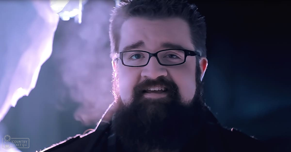 A middle-aged adult male in an indoor setting with dramatic lighting and atmospheric effects.