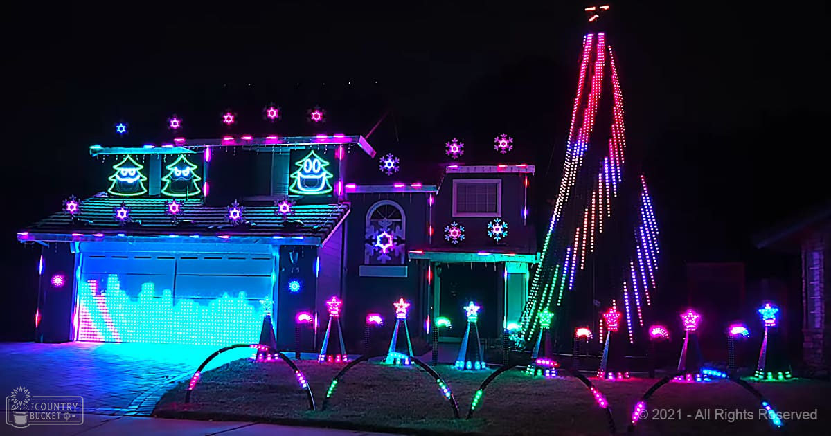 A festively decorated house with colorful LED lights for Christmas in an urban residential area during nighttime.