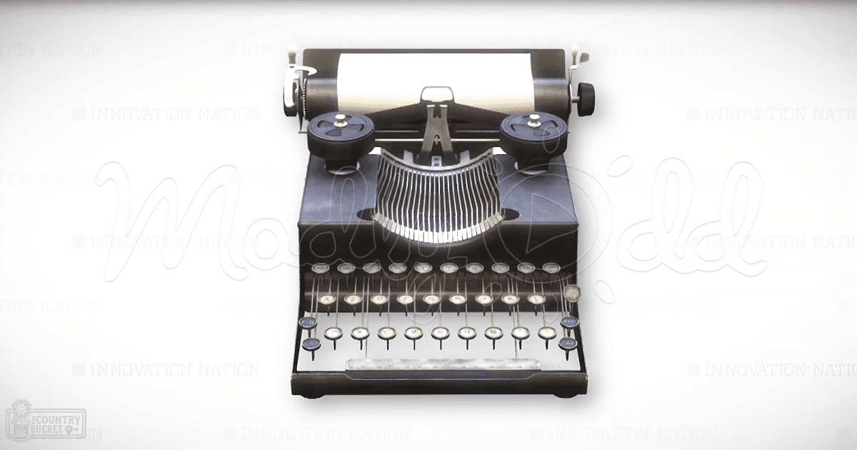 A vintage typewriter with a black body, white paper roll, and keys arranged in rows against a plain white background.
