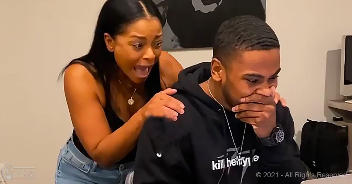 Young adult male and female in a casual indoor setting with computer equipment visible; woman wearing black sleeveless top and jeans, man in black hoodie with 'kill hell yl' text.