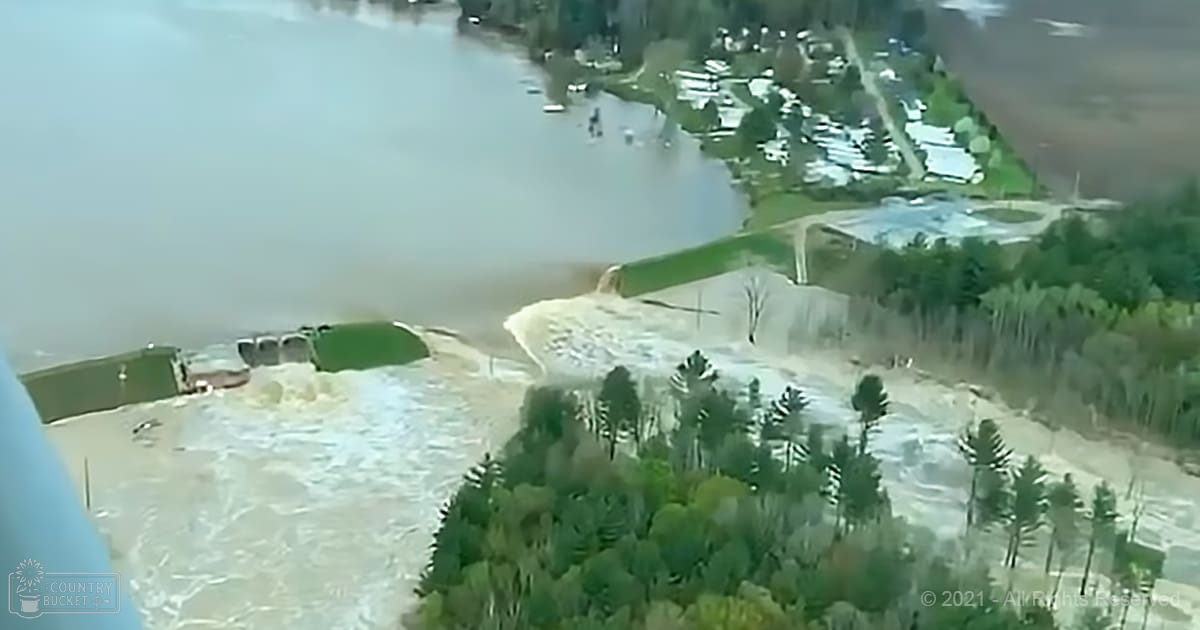 Residential area under floodwater in spring or autumn, muted greens, white and gray floodwaters, overcast light.