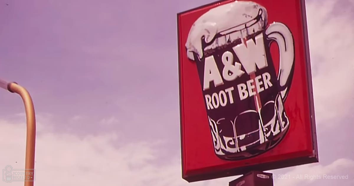 A&W Root Beer sign with a cloudy sky background, suggesting an overcast day.