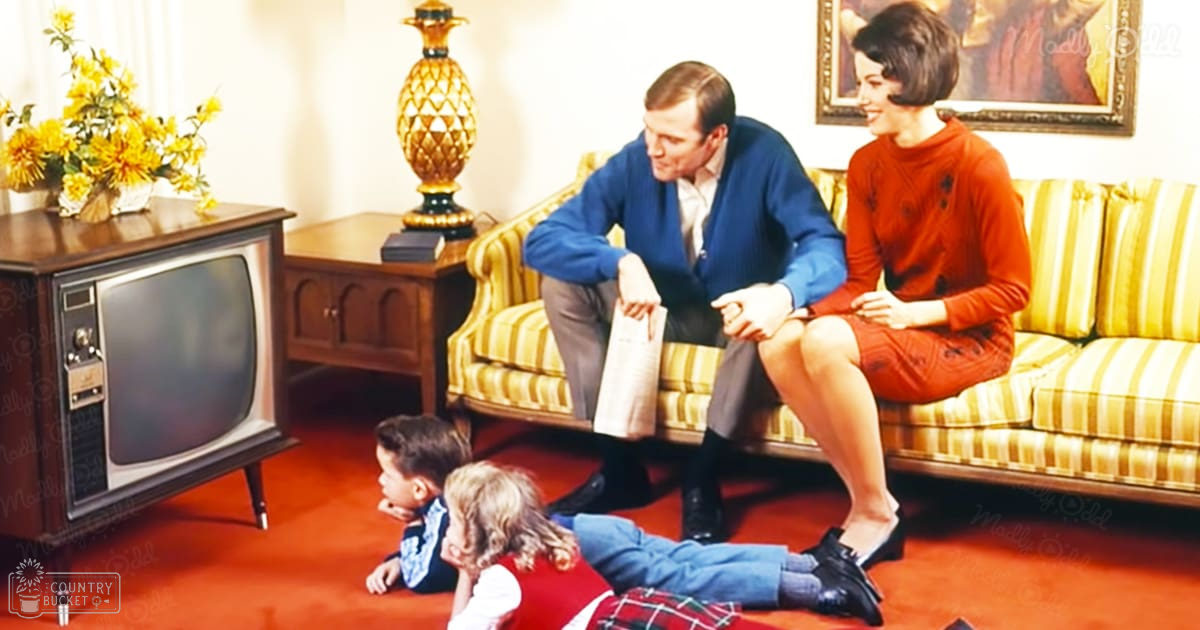 A family with two children in a mid-20th-century living room, with vintage furniture and natural light.