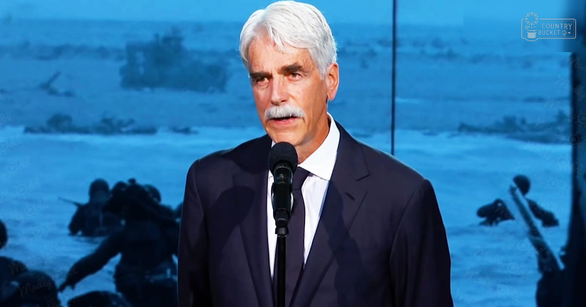 A middle-aged man speaking at an event with a backdrop of soldiers wading through water.