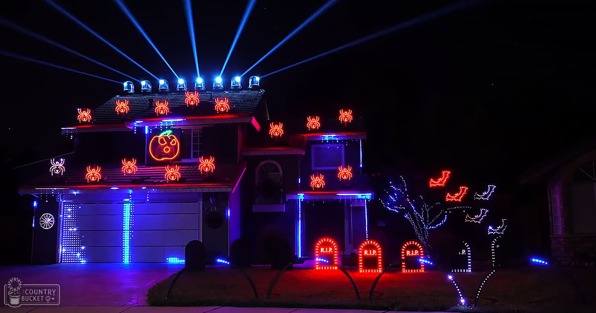 A residential neighborhood adorned with Halloween-themed decorations during the evening.