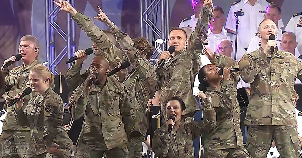 A group of adult males and females performing together at an indoor event or concert under stage lighting.