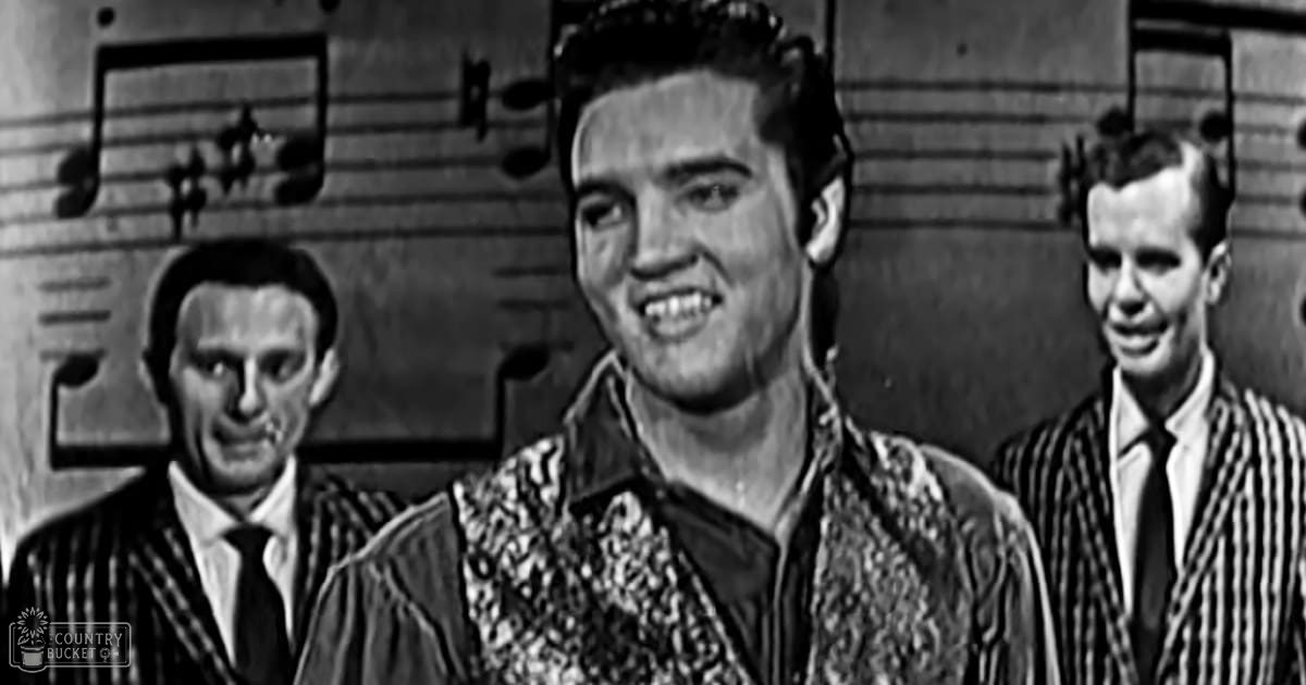 Young adult males wearing formal suits with intricate patterns stand on a stage-like backdrop with musical notes.