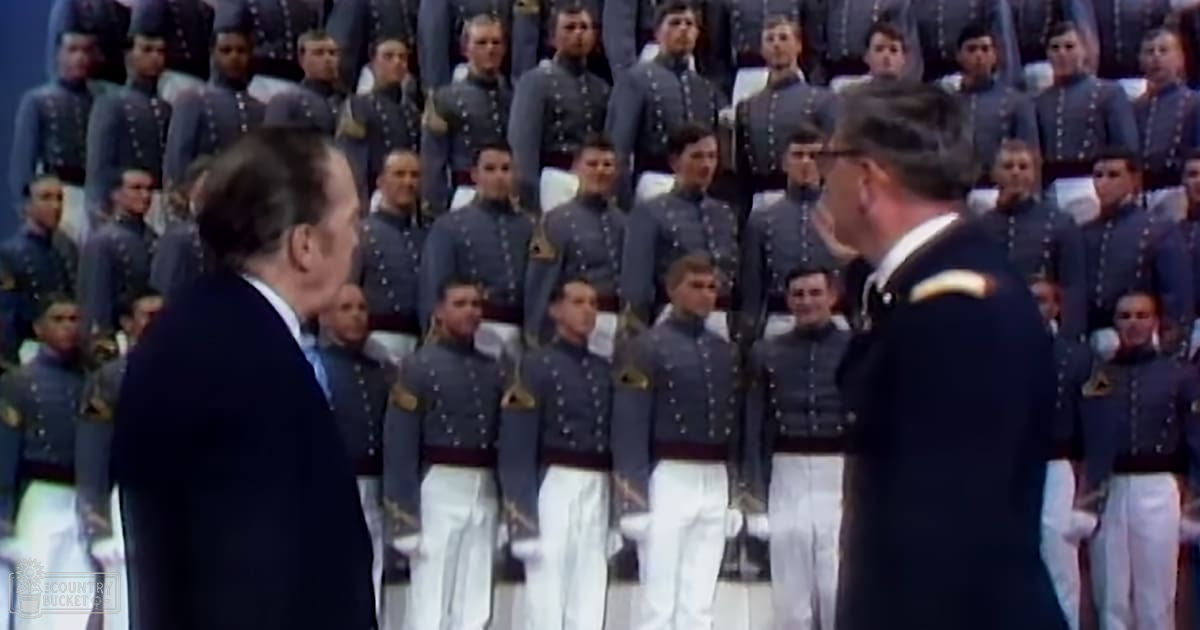 A formal military ceremony at an academy or institution with cadets in uniform, indoors, likely a graduation event.