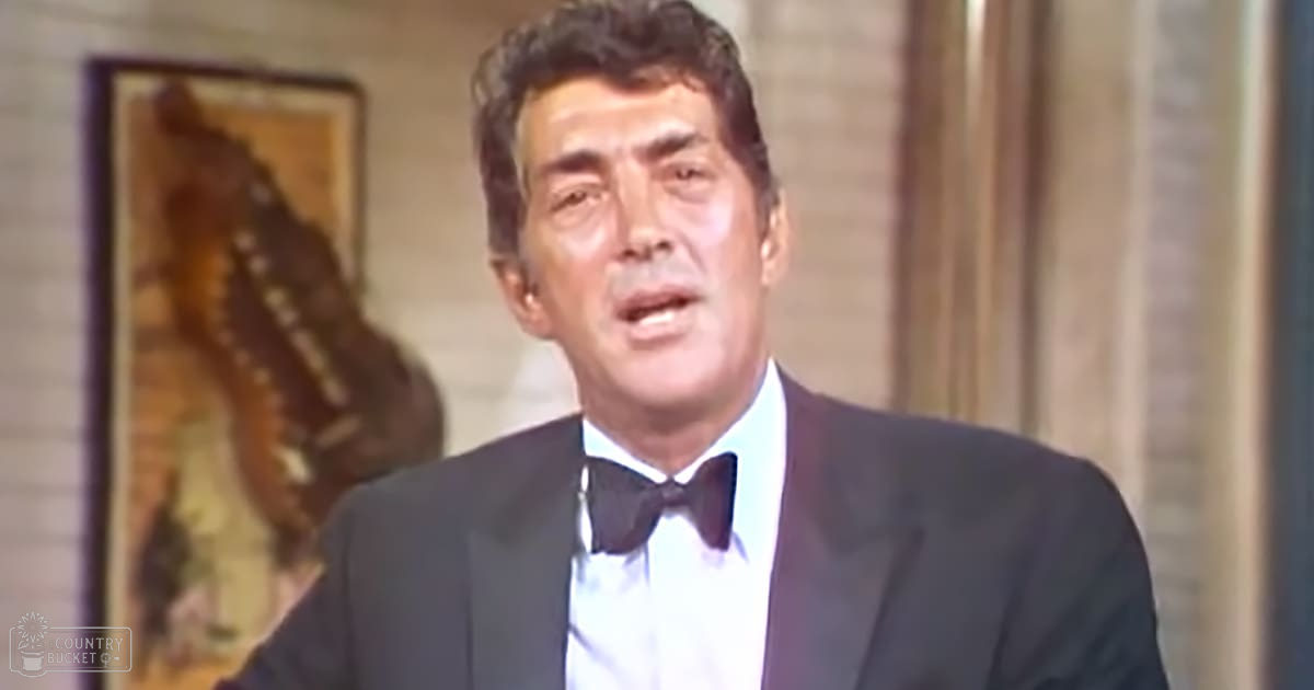 A middle-aged adult male in a tailored tuxedo with a bow tie and white dress shirt, likely from the early to mid-20th century formal attire.