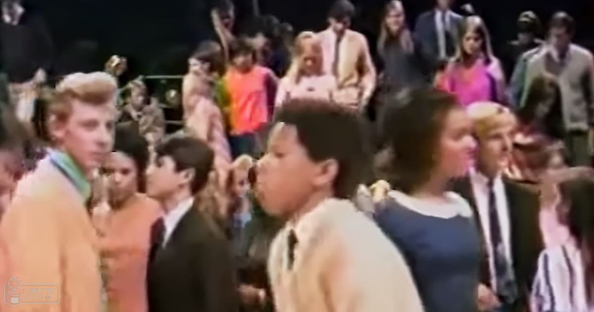 Children performing or participating in a formal event indoors with even bright lighting.