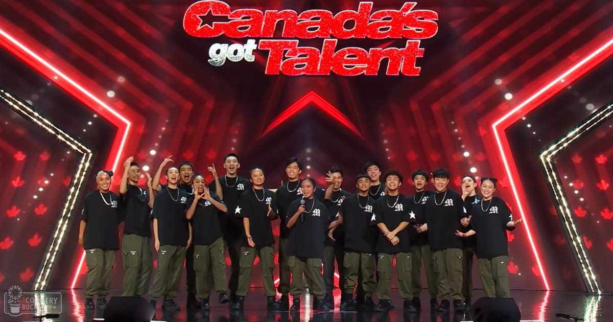 A group of young adults performing on a stage at 'Canada's Got Talent' with red lighting and geometric patterns, wearing matching black t-shirts with white stars and olive green cargo pants.