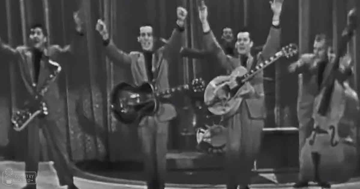 Musical performance from mid-20th century America, likely in a studio setting with adult male performers wearing dark suits and light-colored shirts.