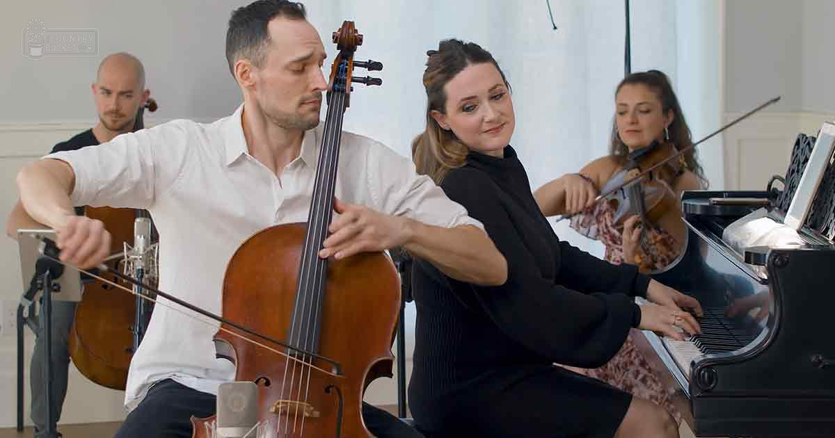 A string quartet performing indoors, with musicians wearing formal and casual attire in a studio-like setting.