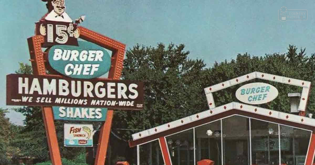 Burger Chef restaurant sign advertising hamburgers and shakes, retro design with red and white trim, outdoor setting near trees suggesting spring or summer