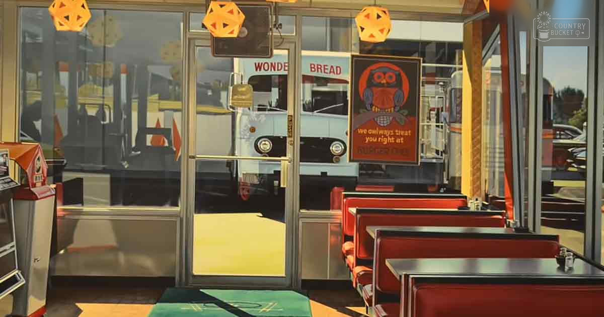 A diner interior with red booth seating, yellow geometric lights, and a Wonder Bread delivery truck reflected in glass doors.