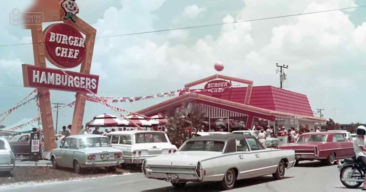 Adults in 1960s attire gather outside a Burger Chef restaurant on a sunny day, with classic cars and palm trees visible.