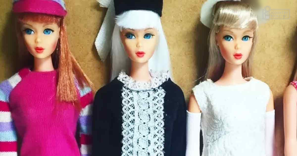 Three dolls displayed against a plain beige wall, with natural lighting suggesting daytime indoors.