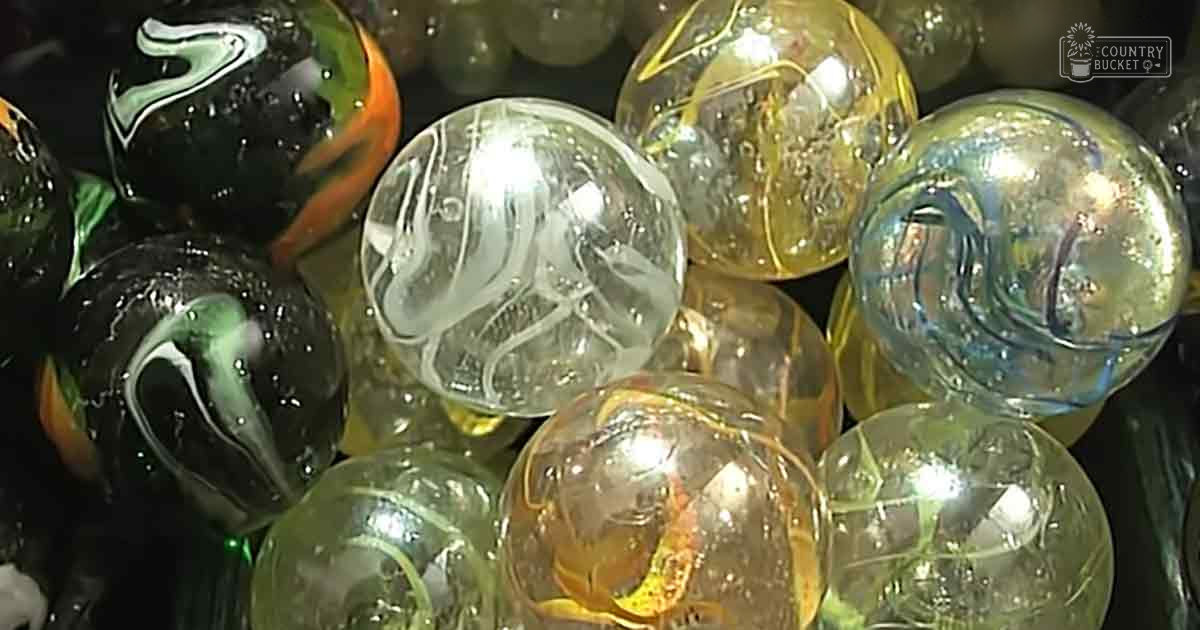 A collection of intricately designed marbles with various colors and patterns indoors.