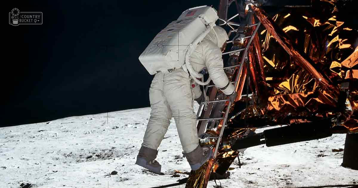 Astronaut in white space suit on the lunar surface, dark void of space and Earth's limb in the background during daylight hours.