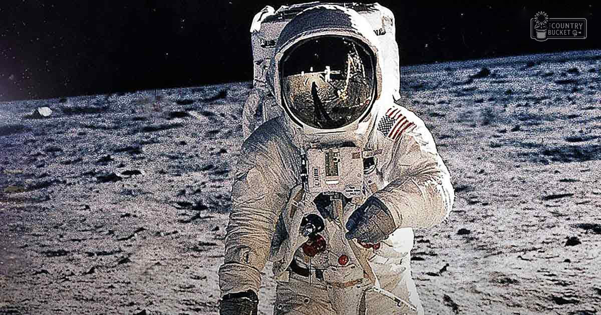 Astronaut in spacesuit on the lunar surface, with a dark sky and scattered rocks visible.