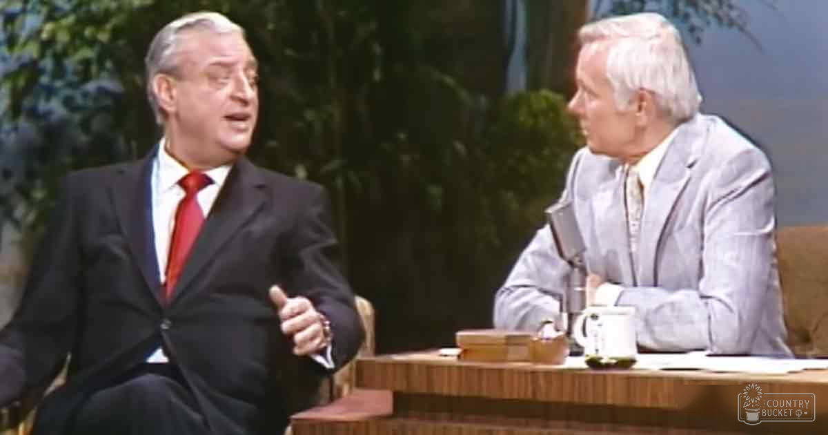 Talk show setting with two adults seated at a desk; indoor daytime scene.