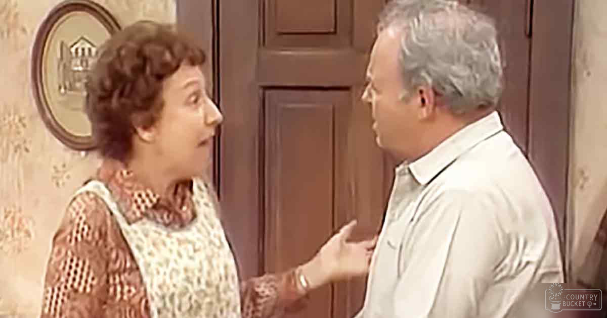 Middle-aged woman and man in an indoor residential setting with vintage-style decor.