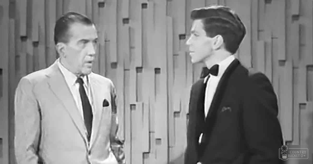Two men dressed in mid-20th-century attire stand side by side against a geometric-patterned studio backdrop.