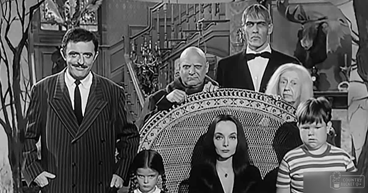 The Addams Family scene indoors with ornate furniture and taxidermy moose head in the background.