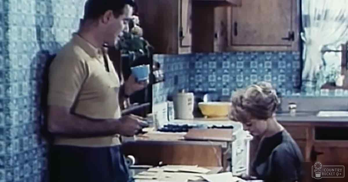 Adult male in a light yellow polo shirt with dark blue jeans, surrounded by kitchen items and preparation tools.